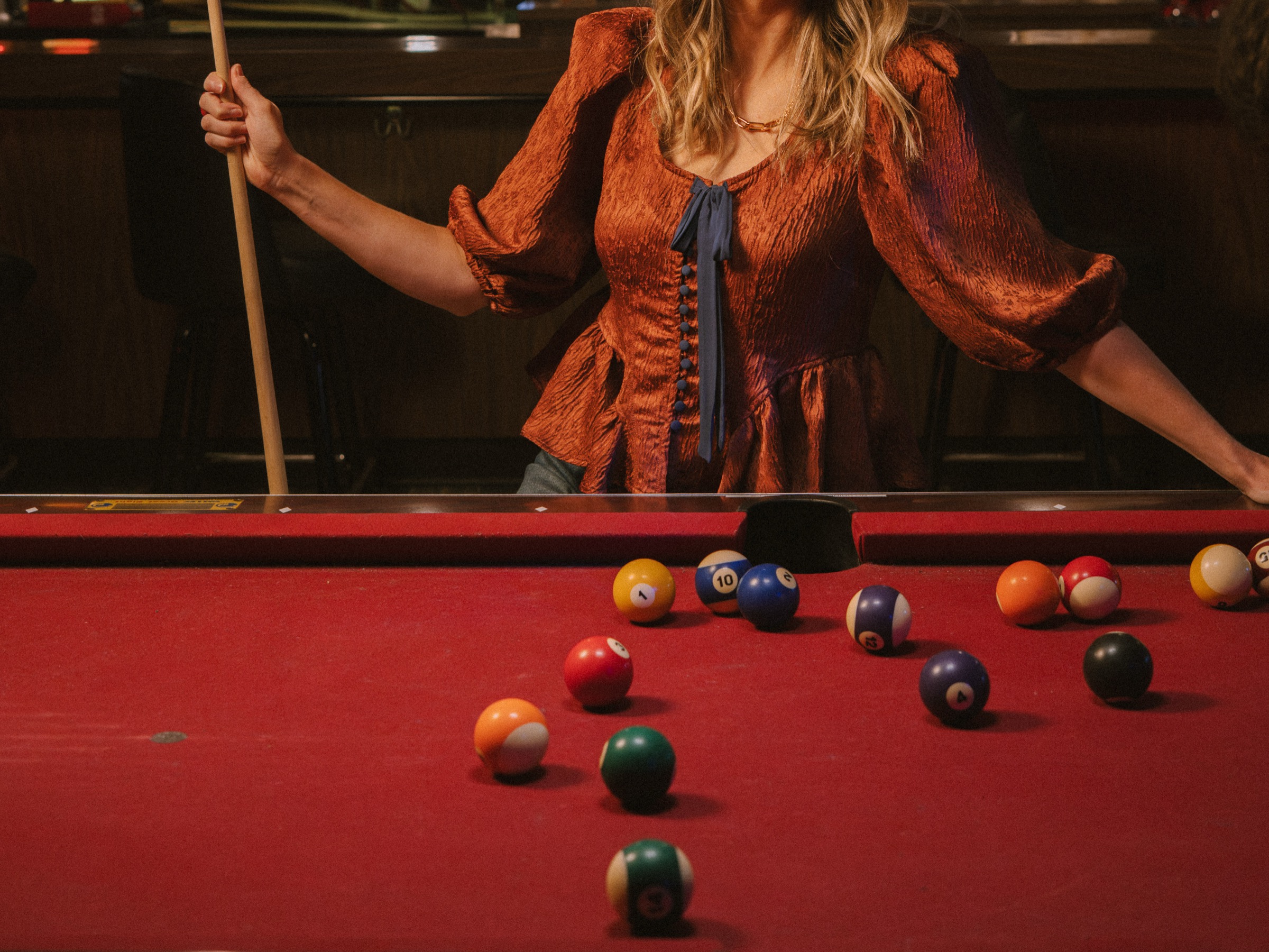 A game of pool on the Brickette table, red felt