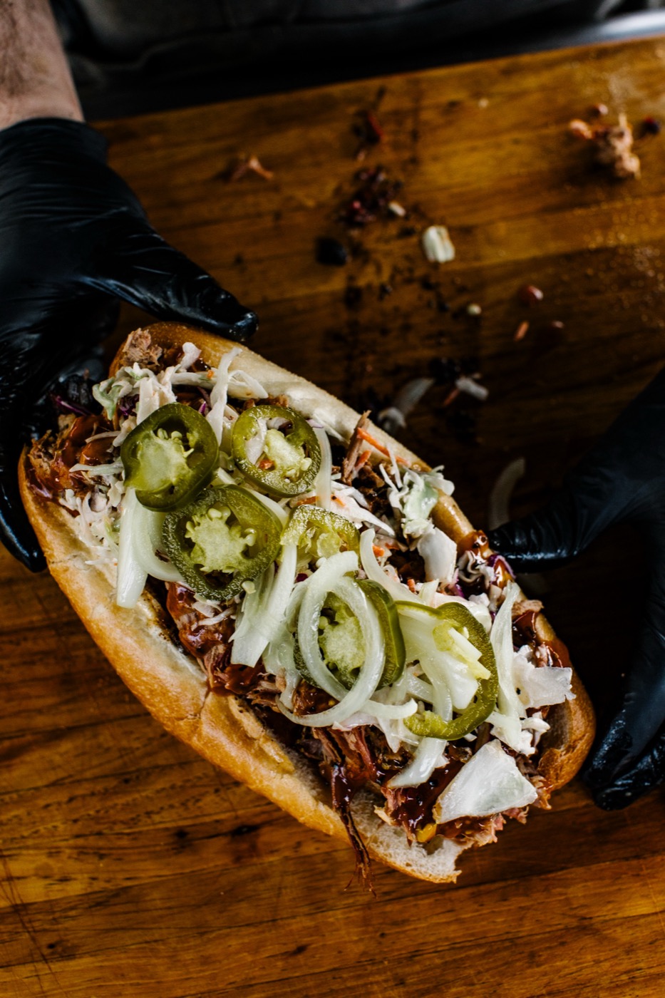 The Brick sandwich held up in gloved hands